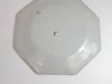 a white plate that has a small hook on it