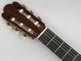 a close up of a guitar with a wooden neck and frets