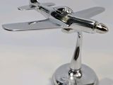 a silver model of a small airplane on a stand