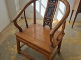 a wooden chair that is sitting in the middle of a room