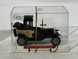 a small toy car in a clear box on a table