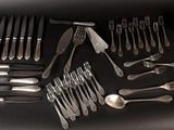a lot of silver spoons and forks on the table