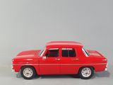 red toy car sitting on a white surface in front of a gray background