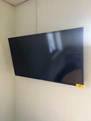 a flat screen tv mounted on the wall in the corner of a room