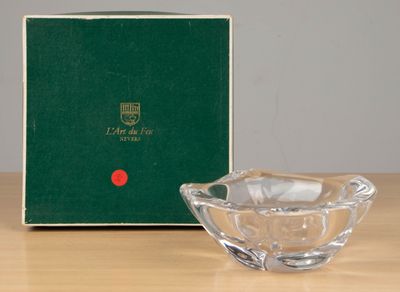 an image of a glass bowl sitting on a table next to a green box