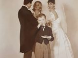 a black and white photo of a bride and groom with a small child