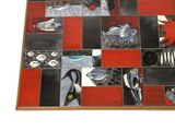 a picture of a red and black tile with scissors on it