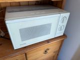 a microwave sitting on top of a dresser in a room