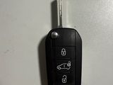 a picture of a car key attached to a wall
