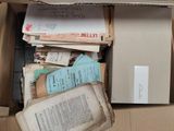 a box full of books and papers sitting on the floor