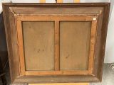 painting on easel with wooden frame and brown paint on it