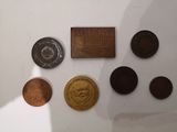 a lot of coins that are on display on the wall