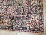 a rug on the floor with a cat laying on it