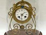 a glass dome with a clock inside of it