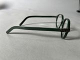a pair of glasses sitting on a table next to a computer mouse