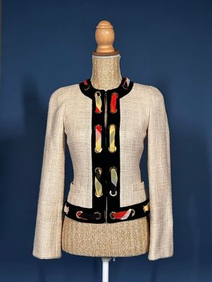 a close up of a dress on a mannequin stand with a blue background