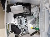 a plastic container filled with assorted electronics on the floor