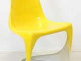 a yellow chair that is sitting in a room