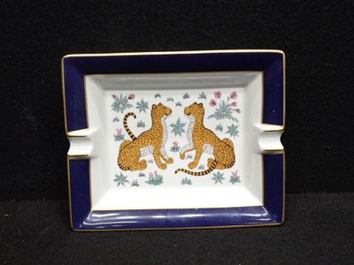 a blue and white plate with a picture of two leopards on it