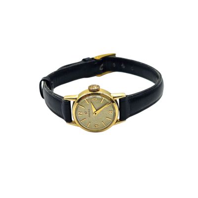 an image of a gold watch with a black leather band