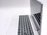 a laptop computer sitting on top of a white table