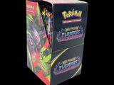 a close up of a box of pokemon trading cards on a black background