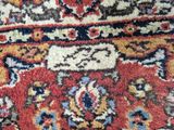 an image of a close up of a rug with a cat laying on it