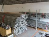 a large pile of steel bars in a warehouse