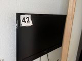 a flat screen tv mounted on the wall next to a door