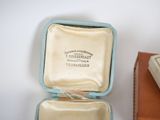 a box with a ring inside of it sitting on a table