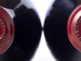 two bottles of wine sitting next to each other on a table