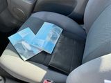 a car seat with a wallet and money in it