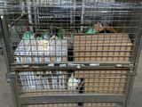 a metal cage with several boxes of food inside of it