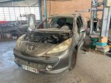 a burnt out car in a garage next to a pile of junk