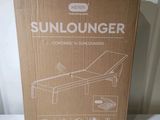 the box is open on the table with the sun lounger in it