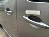 a close up of a car door handle with a sticker on it