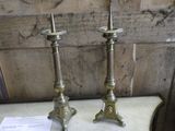 two candles that are sitting on a table next to each other