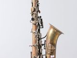 a saxophone that is hanging from the side of a pole