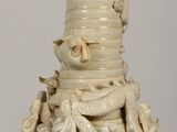 a white vase that has a lot of animals on it