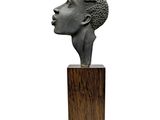 statue of a woman ' s head on a wooden base
