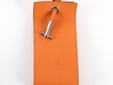 an orange leather case with a metal handle on a white background
