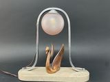 a lamp that is sitting on a stand with a ball