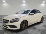 a white mercedes cla parked on a checkered floor
