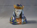 a figurine of a woman with a crown on her head
