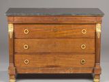 an antique chest of drawers with marble top and brass handles