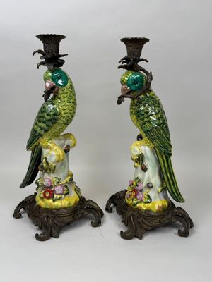 pair of green and yellow parrots on pedestals on a white background