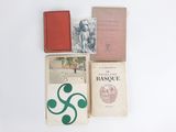 several books are sitting on a white surface next to each other