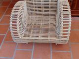 a wicker chair sitting on the floor in a room