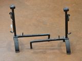 a pair of black iron stands on the floor