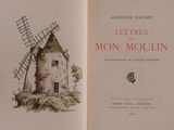 someone is holding a book with a drawing of a windmill on it